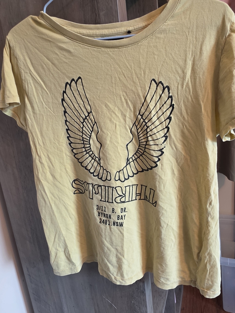 Thrills Yellow Graphic Tee with Black Wing Design